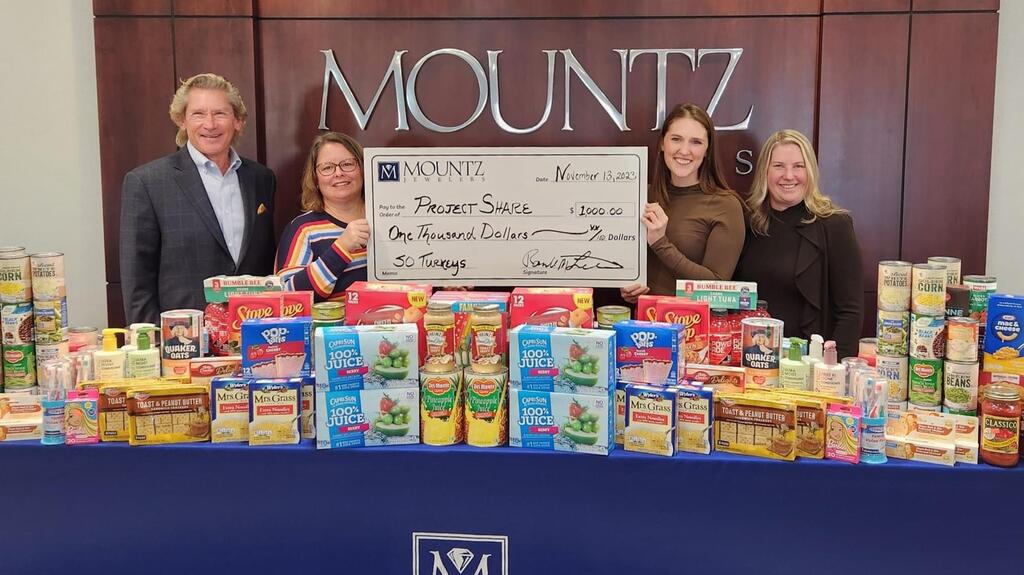 Mountz Jewelers making a $1,000 donation to the nonprofit food program, Project Share Mountz Jewelers donating to Project Share